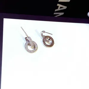 Detailed view of elegant double-loop earrings with shimmering pavé crystals.