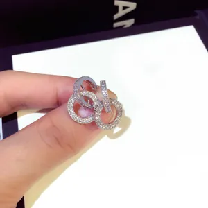 Macro view of micro-pave rhinestone double ring pendant earrings with S925 silver needle