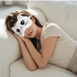 Close-up of cute white plush cat sleep mask worn by model on sofa