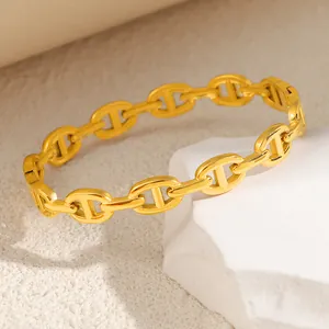 Detailed macro shot of a gold-plated titanium steel pig nose link chain bracelet for women