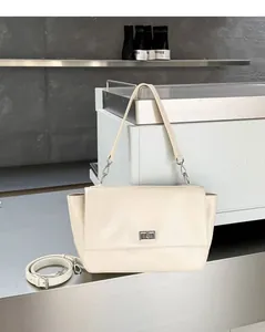 Elegant cream genuine leather flap handbag with silver twist lock and detachable crossbody strap