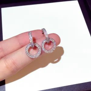 Macro detail of micro-pave double ring pendant earrings in S925 silver