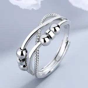 Close-up detail of infinity spinner ring featuring movable silver beads and S925 mark