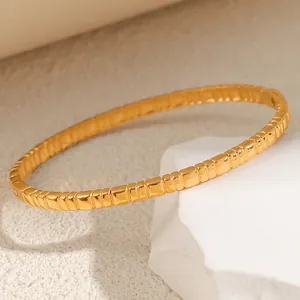 Detailed view of a gold titanium steel bracelet with irregular rectangular block design