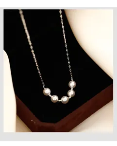 Elegant smile pearl necklace featuring five lustrous round pearls on a silver chain