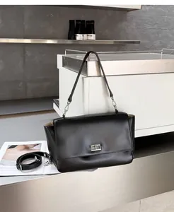 Black genuine leather flap messenger bag with metallic lock detail for commuters