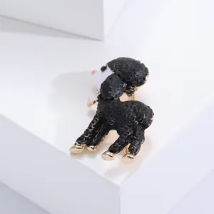 Detailed view of a black enamel poodle brooch with gold-tone accents and texture.