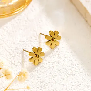 Detailed macro view of 18K gold plated titanium steel daisy flower stud earrings