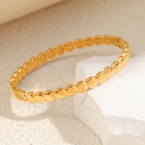 Detail of golden titanium steel bracelet with irregular egg-shaped bead design