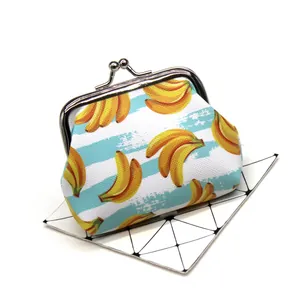 Detailed close-up of a fresh banana print coin purse with a silver metal kiss-lock.