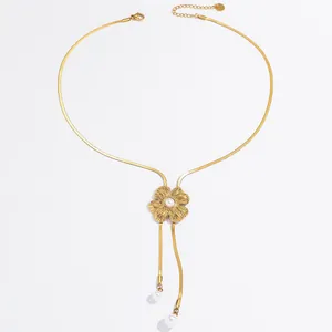 Gold flower tassel necklace with faux pearl pendant and flat snake chain design.