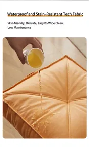 Waterproof tech fabric floor cushion showing stain-resistant orange surface in detail