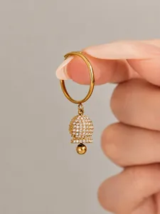 Close-up detail of a chic gold-plated ring featuring a sparkling zircon-encrusted bell