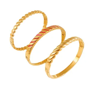 Stylish gold titanium steel bangles set featuring textured beads and enamel stripes