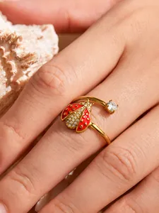 Detailed close-up of a chic ladybug open ring with red enamel and sparkling zircons