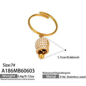 Macro detail view of gold bell pendant ring with sparkling cubic zirconia stones
