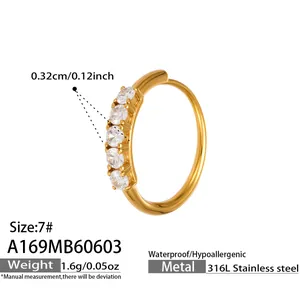 Detail of gold-plated stainless steel ring with five round clear cubic zirconia