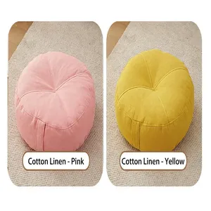 Two round linen futon floor cushions shown in pink and yellow colors for home decor