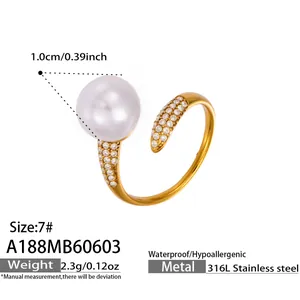 Detailed view of golden 316L stainless steel open ring featuring a large pearl and zircons