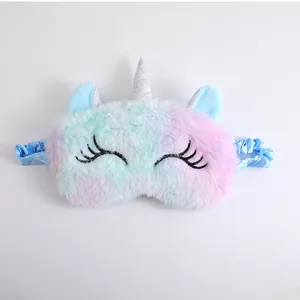 Detail of a soft gradient unicorn plush sleep mask with cute embroidered closed eyes