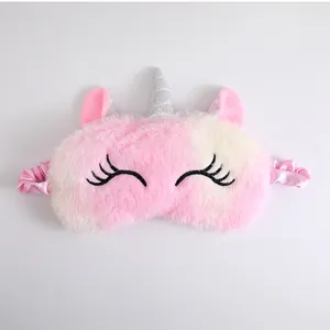 Detailed view of a cute plush unicorn sleep mask featuring pink gradient fur and a silver horn