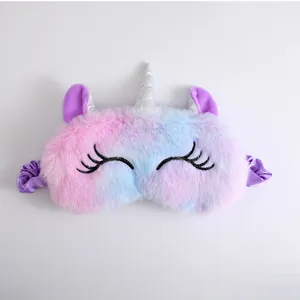 Close-up of cute plush unicorn sleep mask with rainbow gradient and silver horn