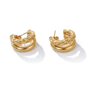 Detailed close-up of gold stainless steel hoop earrings with braided rope texture