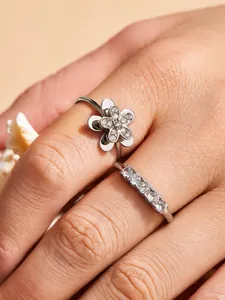 Detailed view of elegant floral and row zircon ring set for women in silver finish