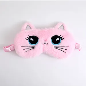 Close-up of a cute pink plush cat sleep mask featuring large embroidered cartoon eyes