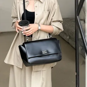 Elegant black leather commuter flap bag with silver lock for women's daily use
