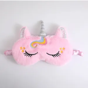 Detail of a soft pink plush unicorn sleep mask with cute embroidered eyelashes