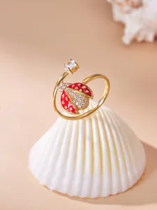 Detailed macro view of a gold-plated ladybug ring set with sparkling cubic zirconia stones