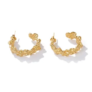 Close-up detail of high-end minimalist gold textured stainless steel hollow hoop earrings
