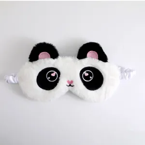 Close-up of a cute panda plush eye mask with soft furry texture and heart pupils.
