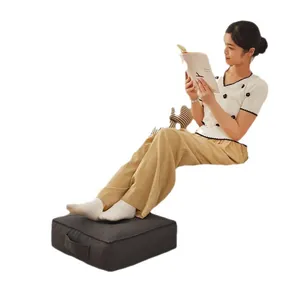Comfortable Japanese style charcoal grey square floor cushion used as a footrest