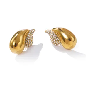 Detail of French style gold-plated stainless steel earrings with sparkling rhinestones.