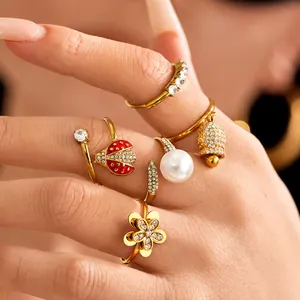 Fashionable gold zircon ring set with ladybug, rotating flower, and pearl charms