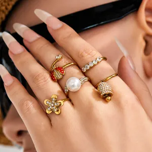 Exquisite set of chic gold rings featuring ladybug pearl and bell designs on hand.