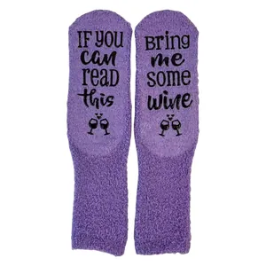 Purple fuzzy socks with 'Bring me wine' non-slip lettering, cozy floor hosiery.