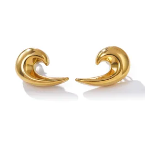 Detailed view of elegant gold-tone wave-shaped hollow earrings with smooth metallic finish.