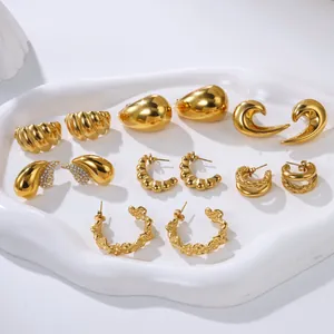 Collection of elegant gold-finished stainless steel earrings displayed on a white tray.