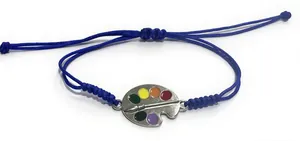 Macro detail of hand-woven blue wax cord bracelet featuring a colorful artist palette