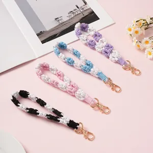 Handmade braided daisy phone lanyard and keychain set in four soft pastel colors
