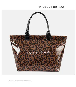 Front view of large leopard print PVC tote bag with black glossy handles