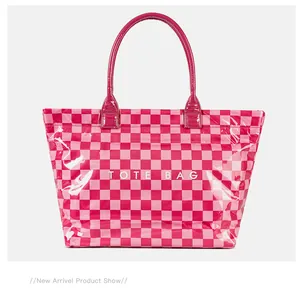 Detailed front view of a vibrant pink checkered PVC tote bag with high gloss finish