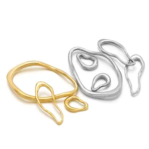 Detailed view of irregular gold and silver stainless steel oval frame pendants for DIY.
