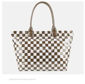 Front view of a stylish brown and white checkered PVC tote bag with white TOTE BAG text