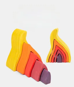 Detailed macro view of fire-shaped wooden stacking blocks in vibrant rainbow colors.