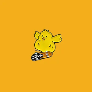 Detail of a cute yellow chick enamel pin riding a skateboard on yellow background.