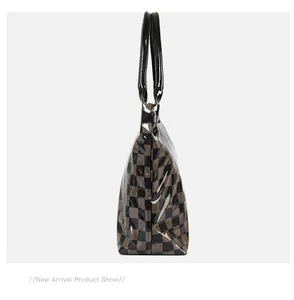Side view of retro brown checkerboard PVC tote bag with black glossy handles